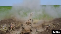 Ukrainian troops use U.S.-supplied M777 howitzer artillery in this photo tweeted by the Ukrainian defense ministry on May 13, 2022.