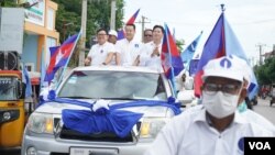 ថ្នាក់ដឹកនាំ​គណបក្ស​ភ្លើងទៀន​ ធ្វើ​ដំណើរ​តាម​ក្បួនដង្ហែ​ឃោស​នា​បក្ស​ នៅ​សង្កាត់​ក្រាំងធ្នង់​ ខណ្ឌសែនសុខ​ រាជធានី​ភ្នំពេញ ថ្ងៃទី​២១ ខែឧសភា ឆ្នាំ២០២២។ (ខាន់​ សុគុំមនោ/វីអូអេ)