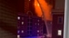 In this image from video, crews spray water on a fire at a residential building in Urumqi in western China's Xinjiang Uyghur Autonomous Region, Nov. 24, 2022. It was the country's second major fire accident this week.