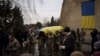 Ukrainian soldiers carry the coffin of Dmytro Kyrychenko near Kyiv, Ukraine, Dec. 23, 2022. Upon returning to Kyiv after visiting the U.S., Ukraine President Volodymyr Zelenskyy said Ukrainian forces “are working toward victory” despite Russia’s relentless attacks on the country.