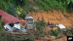 FILE - Rescue teams search for victims caught in a landslide in Batang Kali, Malaysia, Dec. 17, 2022.