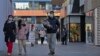 FILE - People walk through a reopened open air shopping mall in Beijing, Dec. 4, 2022. 