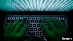 FILE - A person types on a computer keyboard in this Feb. 28, 2013, illustration photo. Two U.S. agencies said Nov. 13, 2024, that a probe has confirmed that Chinese-linked hackers compromised the networks of multiple U.S. telecoms. 