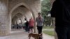 Nali and her owner, Nick Edinger, line up at Austin Oaks Church during the U.S. midterm elections in Austin, Texas, Nov. 8, 2022. (REUTERS/Nuri Vallbona)