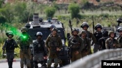 Pasukan Israel berjaga , setelah pemakaman warga Palestina Mohammed Ghoneim, yang menurut petugas medis dibunuh oleh pasukan Israel, dekat Betlehem, di Tepi Barat yang diduduki Israel 11 April 2022. (Foto: REUTERS/Mussa Qawasma)