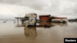 Vehicles are seen submerged in flood water at a petrol station in Lokoja, Nigeria October 13, 2022. 