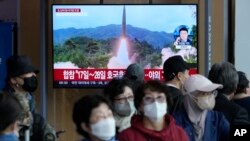 FILE - A TV screen shows a file image of North Korea's missile launch during a news program at the Seoul Railway Station in Seoul, South Korea on Oct. 14, 2022. North and South Korea say they exchanged warning shots early Monday, Oct. 24, 2022, local time.