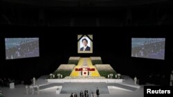 Widow of former Japanese Prime Minister Shinzo Abe, Akie Abe carries her husband's urn during the state funeral for Japan's former Prime Minister Shinzo Abe at the Budokan in Tokyo, Japan, Sept. 27, 2022. (Takashi Aoyama/Pool via Reuters)