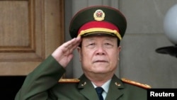 中共中央军委原副主席郭伯雄2006年7月18日在美国五角大楼参加会议前演奏中国国歌的仪式上敬礼。 (资料照片)