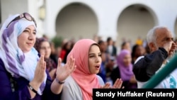 Yesmeena Buzeriba (tengah) bernyanyi bersama mahasiswa lain dalam aksi menentang Islamofobia di San Diego State University di San Diego, California, 23 November 2015. (Foto: REUTERS/Sandy Huffaker)