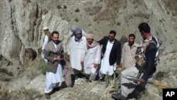 In this picture released by Islamic Republic News Agency, IRNA, Iranian soldiers, center and center left, are welcomed by locals after they were released by Jaish al-Adl [Army of Justice], an al-Qaida-affiliated militant group, at the border with Pakistan