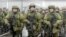 FILE - In this handout photo taken from video released by Russian Defense Ministry Press Service, Russian recruiters stand prior to their military training at the Patriot Park outside in Moscow, Russia, Saturday, Oct. 1, 2022. 