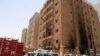 Kuwaiti firefighters and security forces gather outside a building which was ingulfed by fire, in Kuwait City, on June 12, 2024.