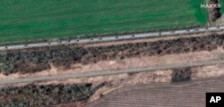 FILE - A satellite image provided by Maxar Technologies shows a convoy of armored vehicles and trucks moving south, around Velykyi Burluk, east of Kharkiv, eastern Ukraine, on April 8, 2022.