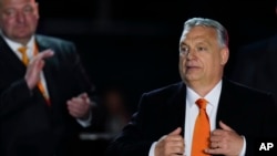 FILE - Hungary's Prime Minister Viktor Orban acknowledges cheering supporters during an election night rally in Budapest, Hungary, April 3, 2022.