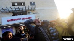 A Palestinian man reacts as casualties from an Israeli strike are brought into a hospital, in Deir Al-Balah in the central Gaza Strip, Jan. 3, 2025.
