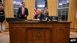 President Donald Trump speaks to journalists as he signs executive orders in the Oval Office of the White House in Washington, on Jan. 20, 2025.