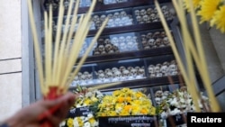 FILE: A man prays at the Choeung Ek memorial during the annual "Day of Anger" where people gathered to remember those who perished during the communist Khmer Rouge regime, outskirts of Phnom Penh, Cambodia, May 20, 2019. REUTERS/Samrang Pring 