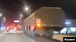 A view through a car window shows Russian missile defense systems driving along a road in Sevastopol, Russian-occupied Crimea, January 27, 2022.