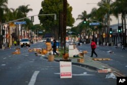 Residents walk across a Lunar New Year festival site after it was canceled due to a mass shooting nearby in Monterey Park, California, Jan. 22, 2023.