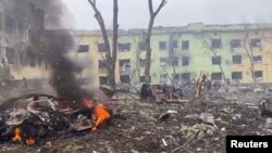 Cars and a building of a hospital destroyed by an aviation strike amid Russia's invasion of Ukraine are seen in Mariupol, Ukraine, in this handout picture released March 9, 2022. (Press service of the National Police of Ukraine/Handout via Reuters)