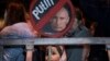 A girl holds a placard depicting Russian President Vladimir Putin at a protest against the Russia's invasion of Ukraine in Tel Aviv, Israel, March 5, 2022.