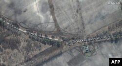 This Maxar satellite image taken and released Feb. 28, 2022, shows the southern end of a Russian military vehicle convoy on T-1011 highway east of Antonov military airport near Kyiv, Ukraine.
