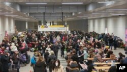 Refugees rest in a subway hall after fleeing from the Ukraine at the main train station in Berlin, Germany, March 14, 2022.