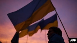 A demonstrator holding a Ukrainian flag participates in a demonstration called by 70 associations in support of Ukraine in Paris on March 17, 2022.