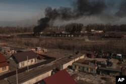 Smoke billows from burning containers after shelling in Vasylkiv, south west of Kyiv, Ukraine, March 12, 2022.
