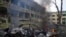 A car burns at the site of a maternity hospital heavily damaged by an airstrike, in Mariupol, Ukraine, March 9, 2022.
