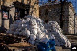 Sandbags protect a building entrance in downtown Lviv, western Ukraine, March 22, 2022.