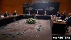 FILE - Turkish Foreign Minister Mevlut Cavusoglu meets with his counterparts from Russia Sergey Lavrov and from Ukraine Dmytro Kuleba in Antalya, Turkey, March 10, 2022. 