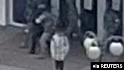 Fotografija napravljena od snimka nadzorne kamere na kojoj se vide ruski vojnici kako odvode čoveka za koga se pretpostavlja da je Ivan Federov, gradnačelnik Melitopolja, grada na jugoistoku Ukrajine koji je pod ruskom kontrolom.