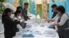 Election commission members count ballots at a polling station in Almaty, Kazakhstan, Nov. 20, 2022. 