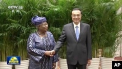 2022年12月8号，中国总理李克强和世界贸易组织总干事恩戈齐·奥孔乔-伊维拉在中国安徽黄山举行会谈前握手拍照。随着中调整其新冠对抗政策，中国有信心使经济恢复持续发展。照片发自中国中央电视台，由美联社提供。