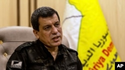 FILE - Syrian-Kurdish commander Mazloum Abdi, of the U.S.-backed Syrian Democratic Forces, speaks in Hassakeh, Syria, Nov. 26, 2022. On Monday, he congratulated Donald Trump in his reelection as president of the United States.