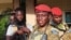 FILE - Burkina Faso's military leader Ibrahim Traore is escorted by soldiers in Ouagadougou, Burkina Faso, Oct. 2, 2022.