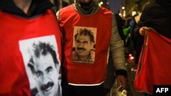 FILE - People wearing jerseys with the face of Abdullah Ocalan, leader of the Kurdistan Workers' Party, are pictured during an event in Paris, Dec. 24, 2022.
