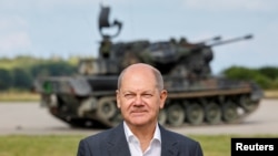 Kanselir Jerman Olaf Scholz berdiri di depan senjata antipesawat self-propelled Jerman Flakpanzer Gepard selama kunjungan program pelatihan untuk tentara Ukraina di tank anti-pesawat Gepard di Putlos dekat Oldenburg, Jerman 25 Agustus 2022. (Axel Heimken/ Pool via REUTERS)