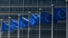 FILE - Flags fly outside the European Commission building in Brussels, June 16, 2022.