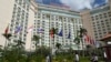 People walk in front of the Sokha hotel during the 55th ASEAN Foreign Ministers Meeting (55th AMM) in Phnom Penh, Aug. 2, 2022.