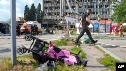 FILE - A baby stroller lies by a road after a deadly Russian missile attack in Vinnytsia, Ukraine, July 14, 2022.