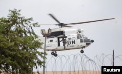A United Nations Organization Stabilization Mission in the Democratic Republic of the Congo (MONUSCO) peacekeeper rides on a helicopter above the compound of U.N. peacekeeping force's warehouse in Goma in the North Kivu province of the Democratic Republic of Congo, July 26, 2022.