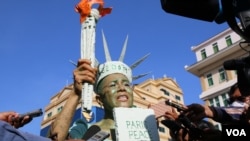 រូបឯកសារ៖ កញ្ញា សេង ធារី មេធាវីខ្មែរ-អាមេរិកាំង តែងខ្លួនជារូបសំណាក​សេរីភាព Statue of Liberty ឈរថ្លែងនៅខាងមុខសាលាដំបូងរាជធានីភ្នំពេញ មុនពេលត្រូវបានចាប់ខ្លួន នៅថ្ងៃទី១៤ ខែមិថុនា ឆ្នាំ២០២២។ (កាន់ វិច្ឆិកា/វីអូអេ)