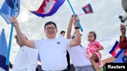 Vice President of Candlelight Party, Son Chhay, waves flags during a campaign rally for the upcoming local elections on June 5, in Phnom Penh, Cambodia May 21, 2022. Picture taken on May 21, 2022. (REUTERS/Lach Chantha)