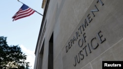 FILE - Signage is seen at the United States Department of Justice headquarters in Washington, Aug. 29, 2020. 