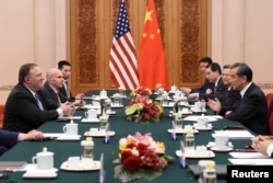 Chinese Foreign Minister Wang Yi, right, meets with U.S. Secretary of State Mike Pompeo, left, at the Great Hall of the People in Beijing on June 14, 2018.