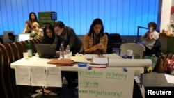 Volunteer immigration attorneys organize to help as people gather to protest against President Donald Trump's executive order travel ban at Los Angeles International Airport, Jan. 31, 2017.