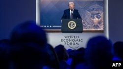 U.S. President Donald Trump is seen on a large screen during his address by videoconference at the World Economic Forum annual meeting in Davos, Switzerland, Jan. 23, 2025.